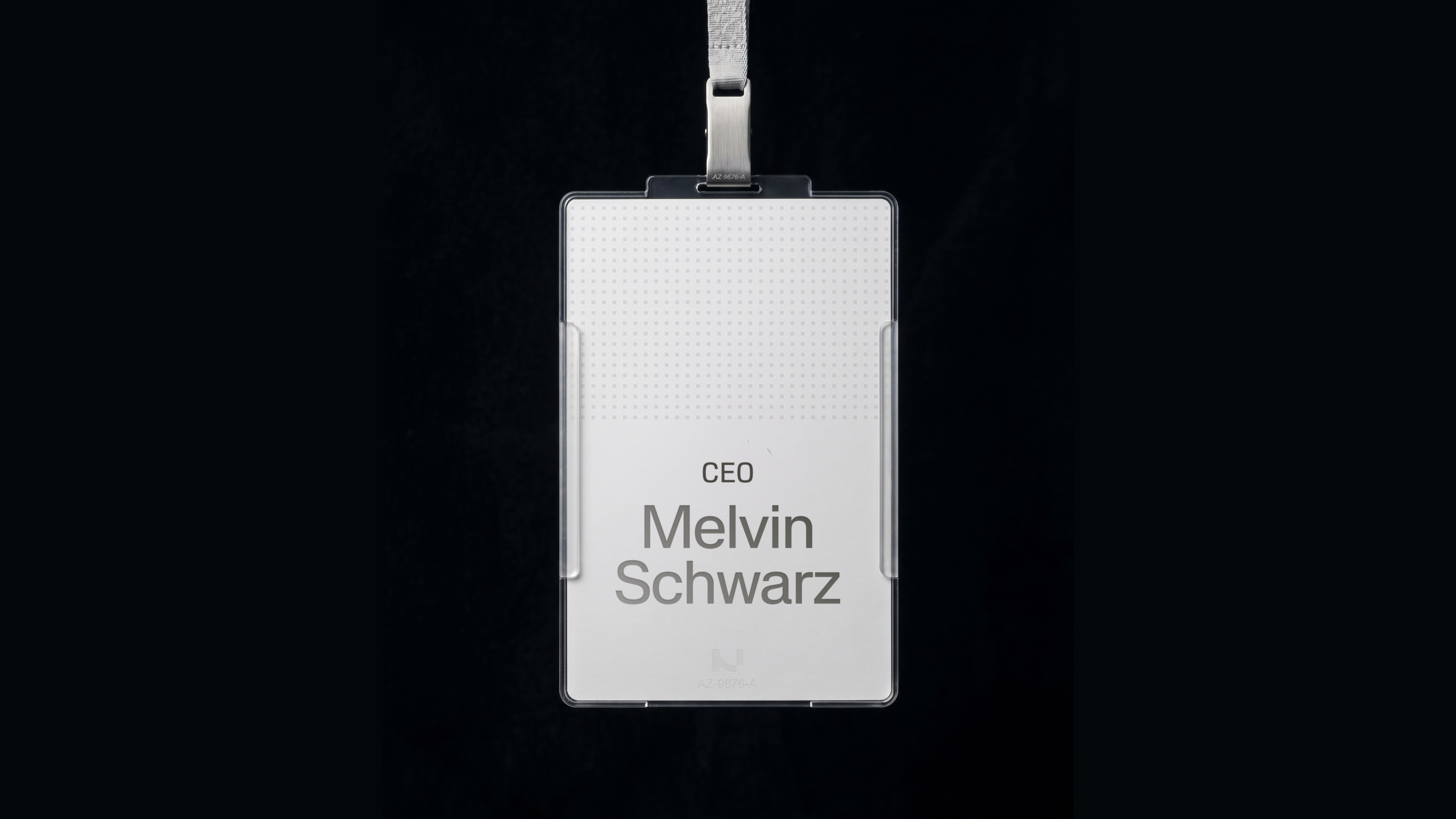Nucleus ID badge on a lanyard against a black background, the white card printed with the role CEO and the Nucleus mark